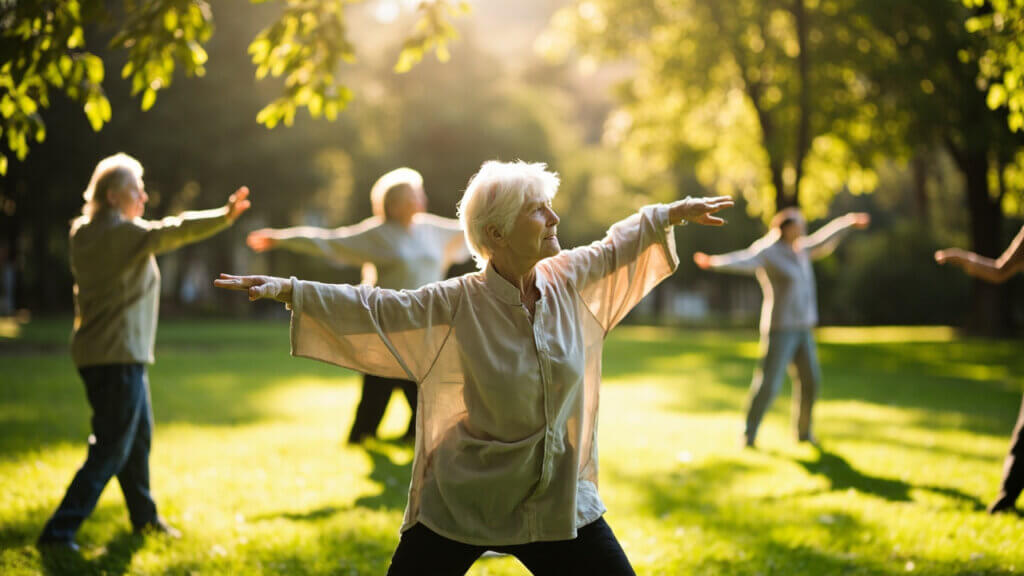 Older adults performing gentle Tai Chi movements in the park for joint relief