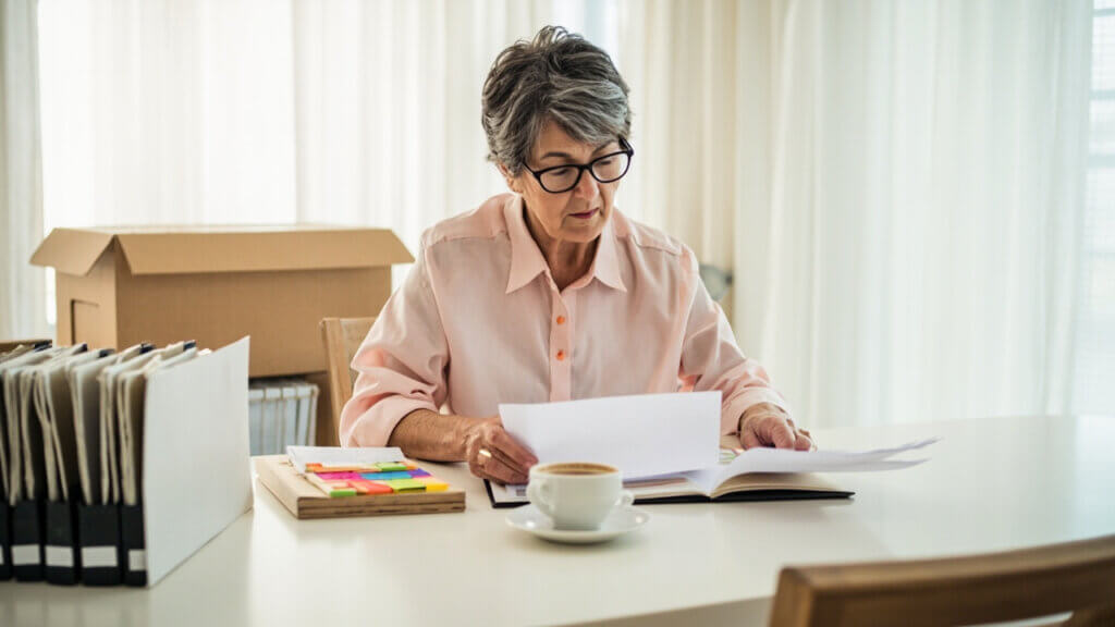 Senior woman organizing important documents before a move