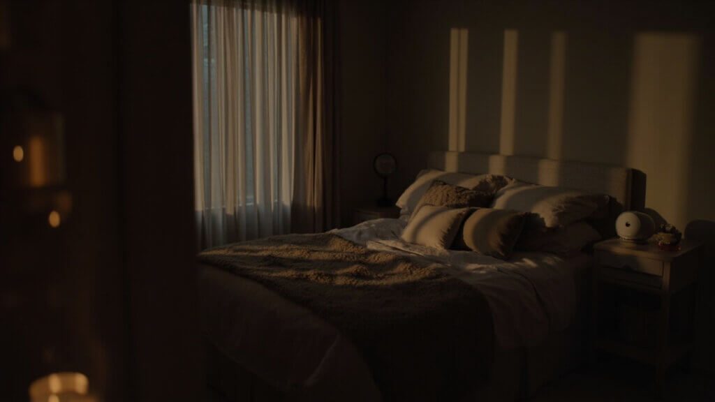 Sleep-optimized bedroom setup with low lighting and blackout curtains