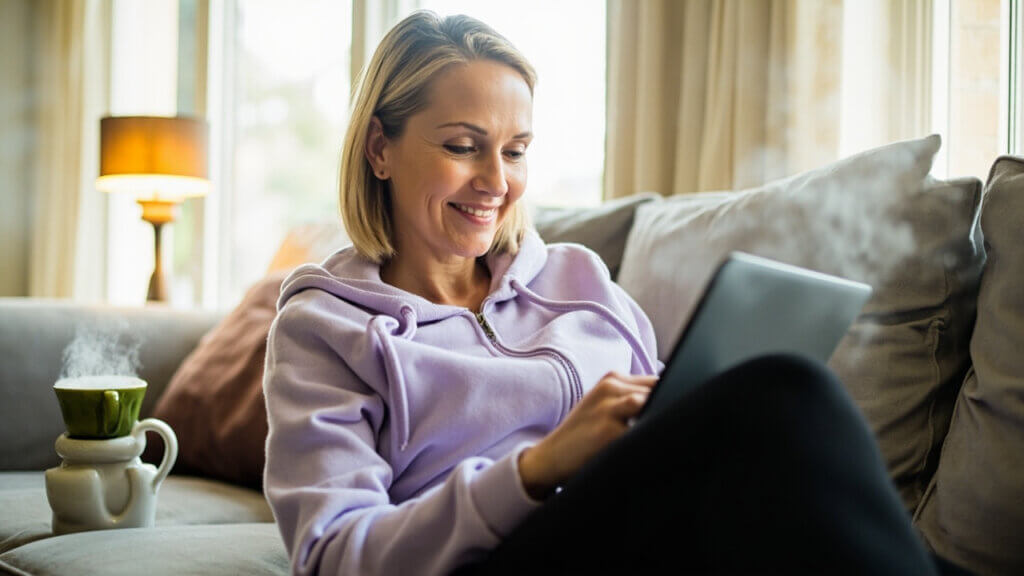 Senior woman enjoying a brain training app on her tablet as part of her mental wellness routine