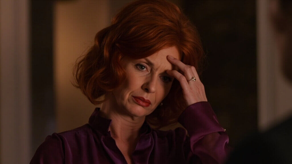 Middle-aged woman struggling to recall a word in a conversation