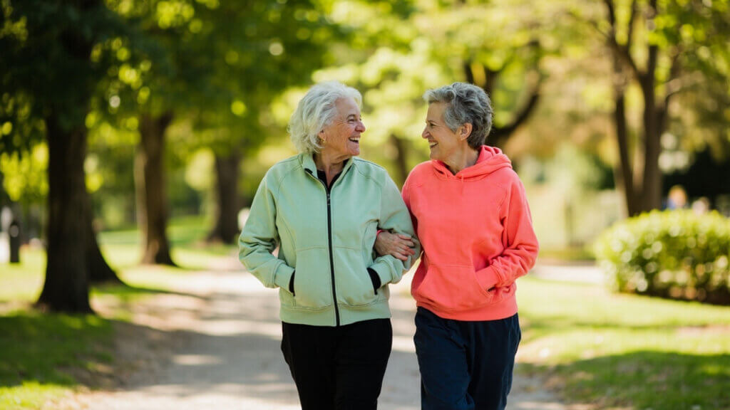 Two senior women enjoying a walk together and sharing a laugh